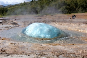 At the Geysir geothermal site, the Strokkur geyser forms a magnificent turquoise bubble that swells before exploding into a 20 m-high column of boiling steam.