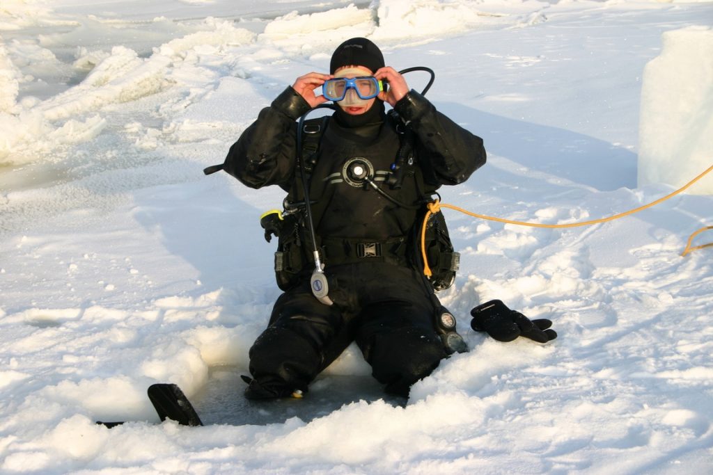 Norway. King crab fishing. The fisherman adjusts his glasses before plunging into the icy water. 