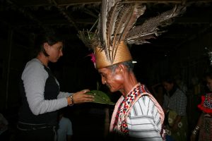 Borneo_young-woman-of-the-group-making-an-offering-to-the-house-spirits_