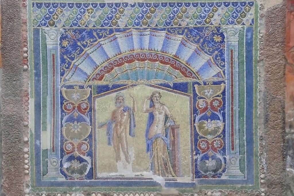 Herculaneum. The House of Sannitica dates back to the 2nd century BC and is one of the oldest houses in the town uncovered in the early 20th century. This wall mosaic depicts Neptune and Amphitrite.