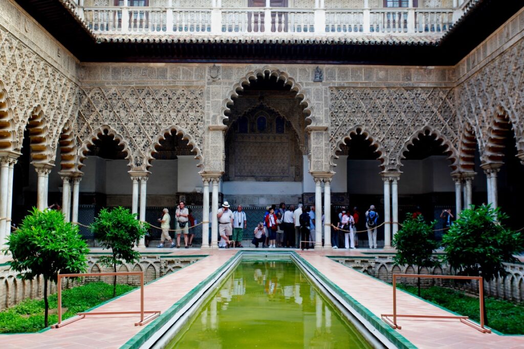 Seville. Alcazar. Patio de las Doncellas. A rectangular courtyard with a series of lobular arches supported by double marble columns on the ground floor and, on the upper floor, an arcade supported by small Ionian marble columns with a balustrade added around 1540 during the reign of Charles V.