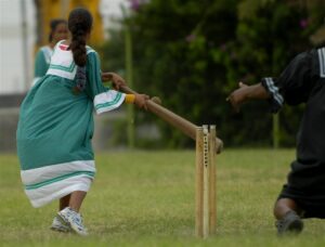 Female cricketer in mission dress. New Caledonia. © https://presencekanak.com/2020/11/29/le-cricket-feminin-en-nouvelle-caledonie/