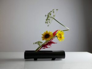 Ikebana. Sogetsu school. Moribana style. Sunflower and umbelliferae.