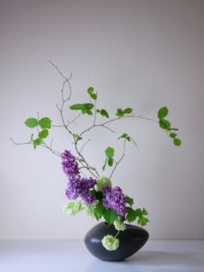 Ikebana. Sogetsu school. Free style: lilac, hazel and viburnum.