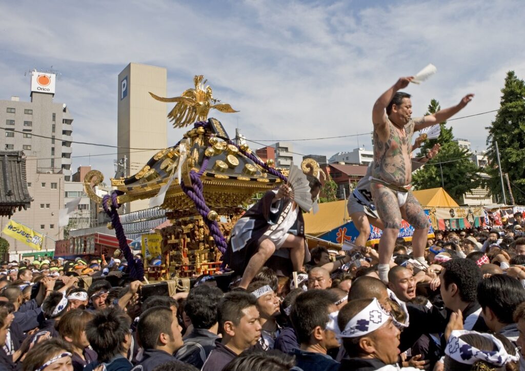 Japan. On the third weekend in May, the yakuza show off their tattoo-stained torsos at the much-loved Sanja Matsuri festival. The procession brings together 200 "Mikoshi" or altars on a mobile palanquin.