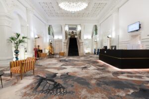 Belfort. Entrance hall of the Grand Hôtel du Tonneau d'Or, featuring a monumental staircase and decorated with stained-glass windows by Jacques Gruber, a master craftsman from Nancy.