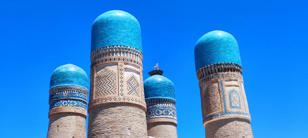 Boukhara. Medersa of Chor Minor. Storks have taken up residence on one of the towers.